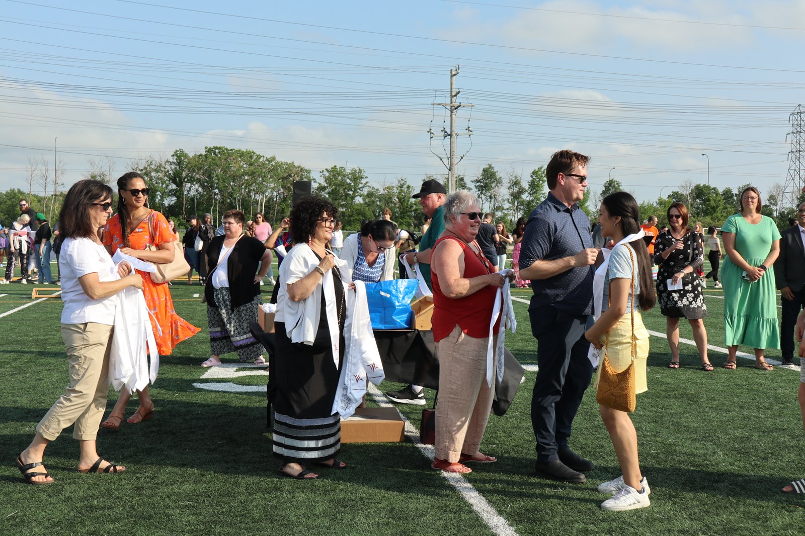 Trustees and SLT handing out grad stolls