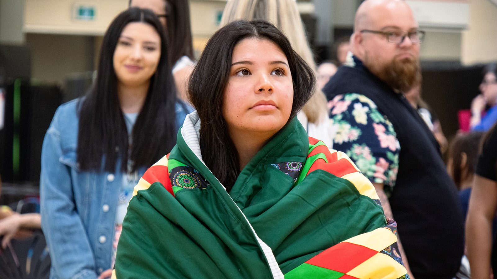 Kiera Flett wrapped in a green Starblanket