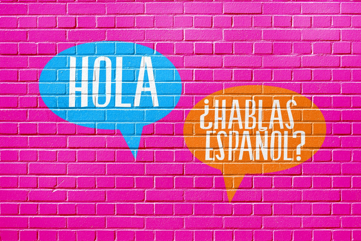 Hola and Hablas Espanol in word balloons on wall
