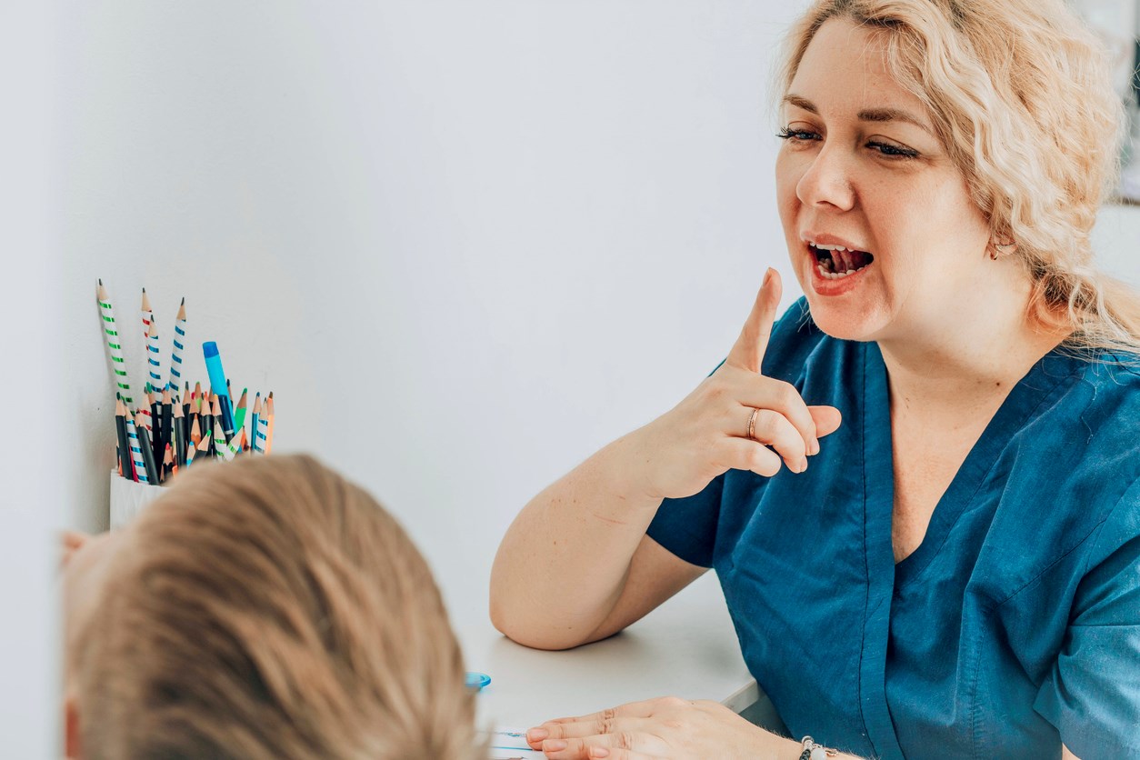 Speech pathologist with child