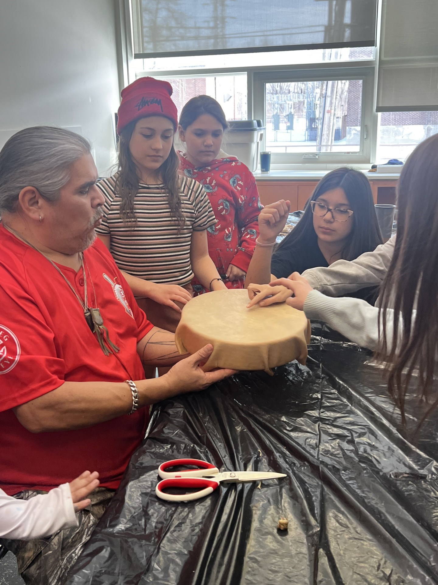 Knowledge Carrier Eric Flett with students from Marion School making a hand drum