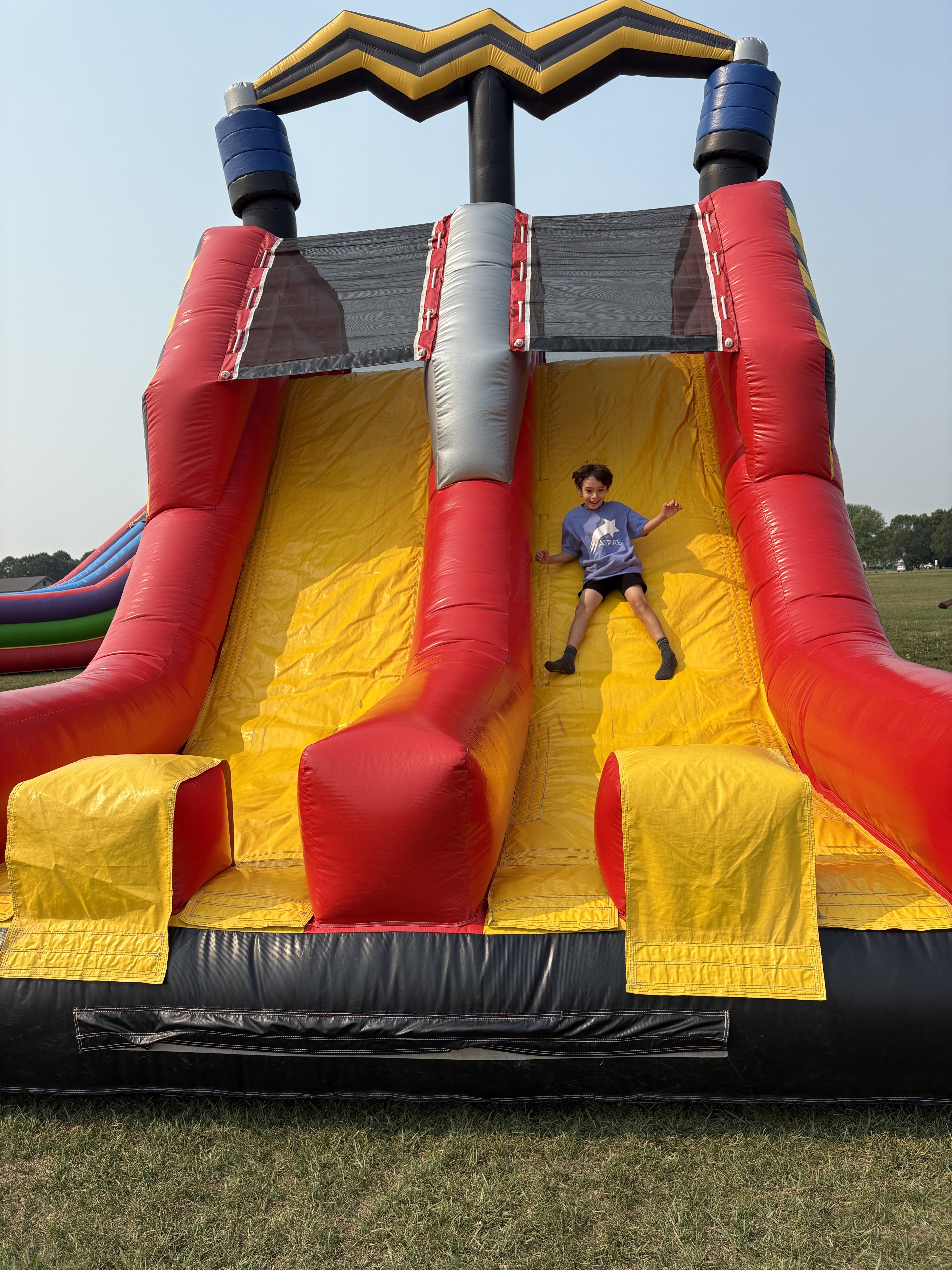 Student sliding down a bouncy slide
